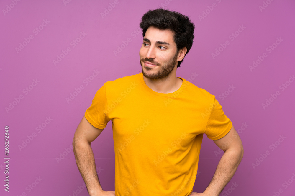 Handsome over isolated purple wall making doubts gesture looking side Handsome over isolated purple wall making doubts gesture looking side