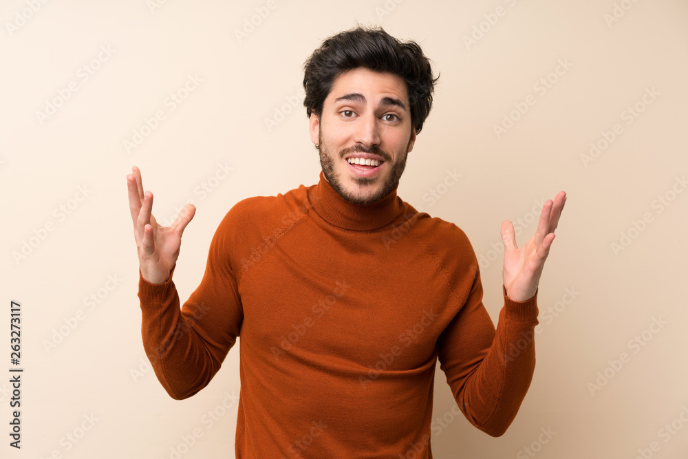 Handsome over isolated wall smiling a lot Handsome over isolated wall smiling a lot