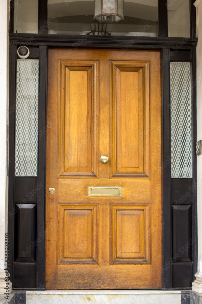 Wooden Entrance Door to residential building in London. Typical door in the English style.