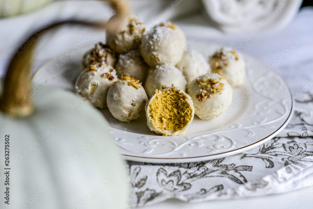tasty homemade pumpkin candy balls in white chocolate topping of nut crumbs tasty homemade pumpkin candy balls in white chocolate topping of nut crumbs