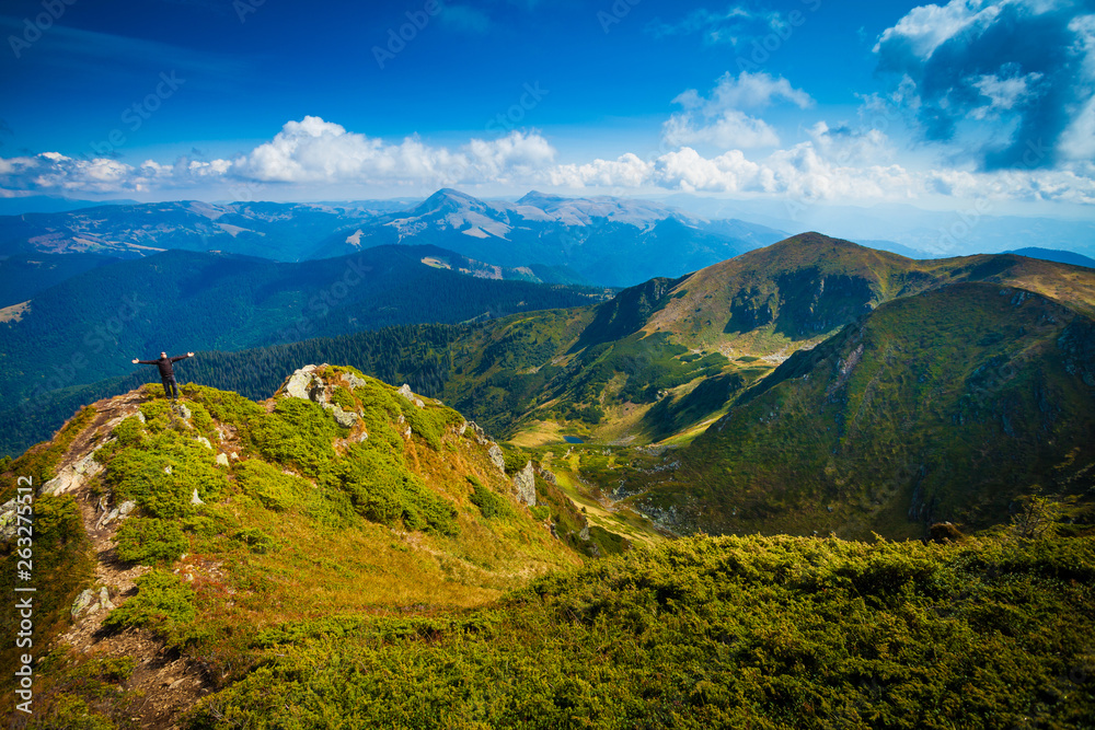 Fototapeta premium Hiker in beautiful mountain landscape, sense of freedom concept