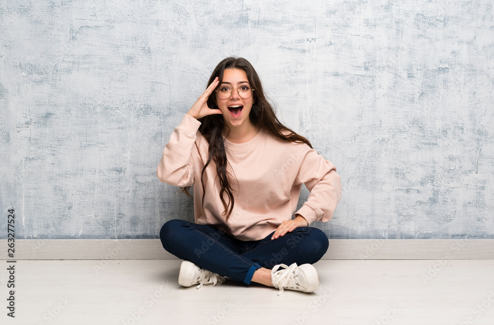Teenager student girl studying in a table with surprise and shocked facial expression Teenager student girl studying in a table with surprise and shocked facial expression