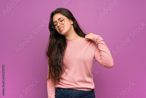 Teenager girl over purple wall with tired and sick expression