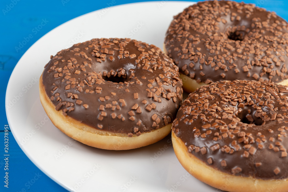 Donut With Chocolate Topping Cream On The Blue Background