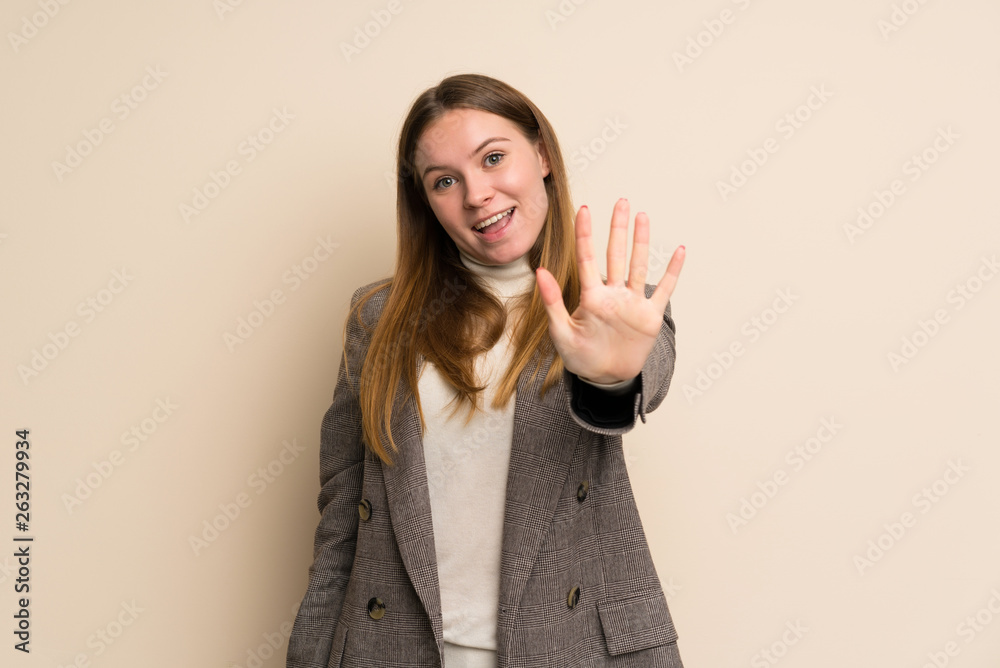 Young business woman counting five with fingers