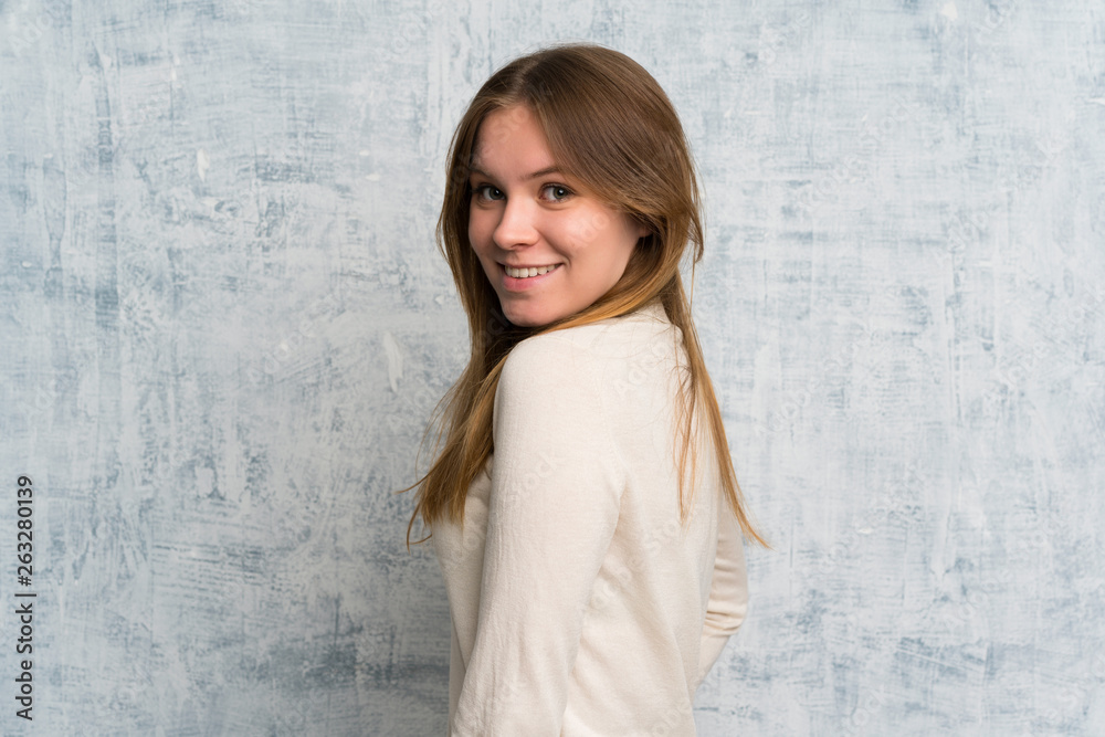 Fototapeta premium Young woman over grunge wall laughing