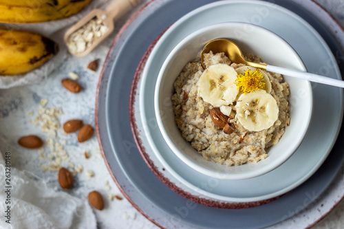 oatmeal porridge with banana and almond, top view