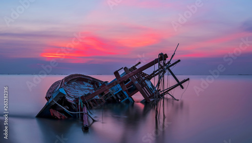 Shipwreck in Kratinglay beach Chonburi with beautiful sunset and twilight sky © Pugun & Photo Studio