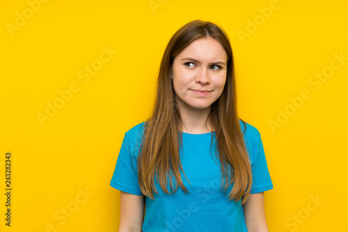 Young woman with blue shirt standing and looking to the side