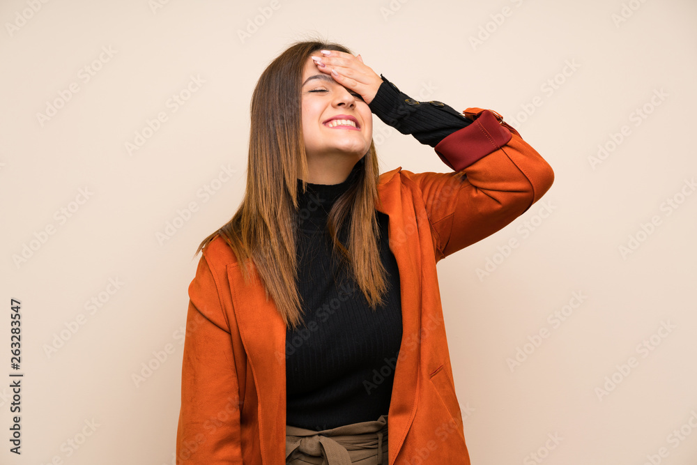 Young woman with coat laughing Young woman with coat laughing