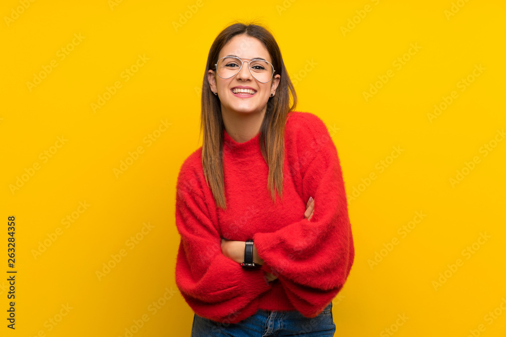 Young woman over isolated yellow wall laughing Young woman over isolated yellow wall laughing