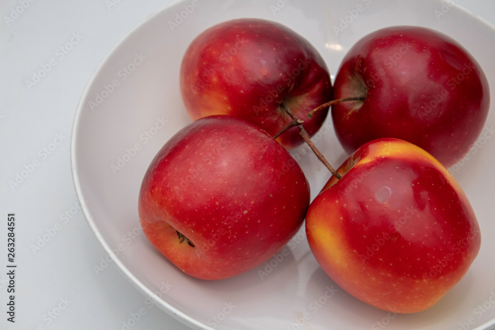 four apples in a bowl