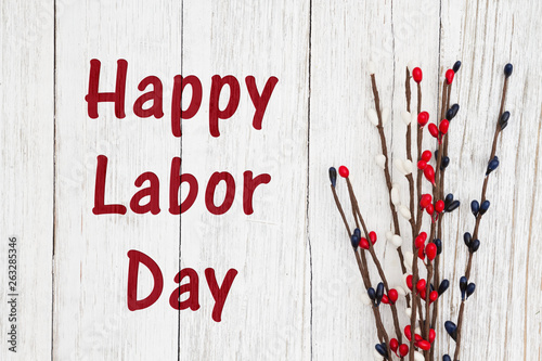 Happy Labor Day text with red, white and blue berry spray