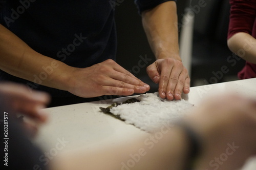 hands of man and woman working in workshop