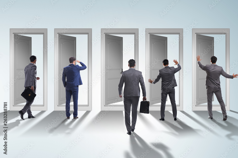 Businessman in uncertainty concept with many doors Businessman in uncertainty concept with many doors