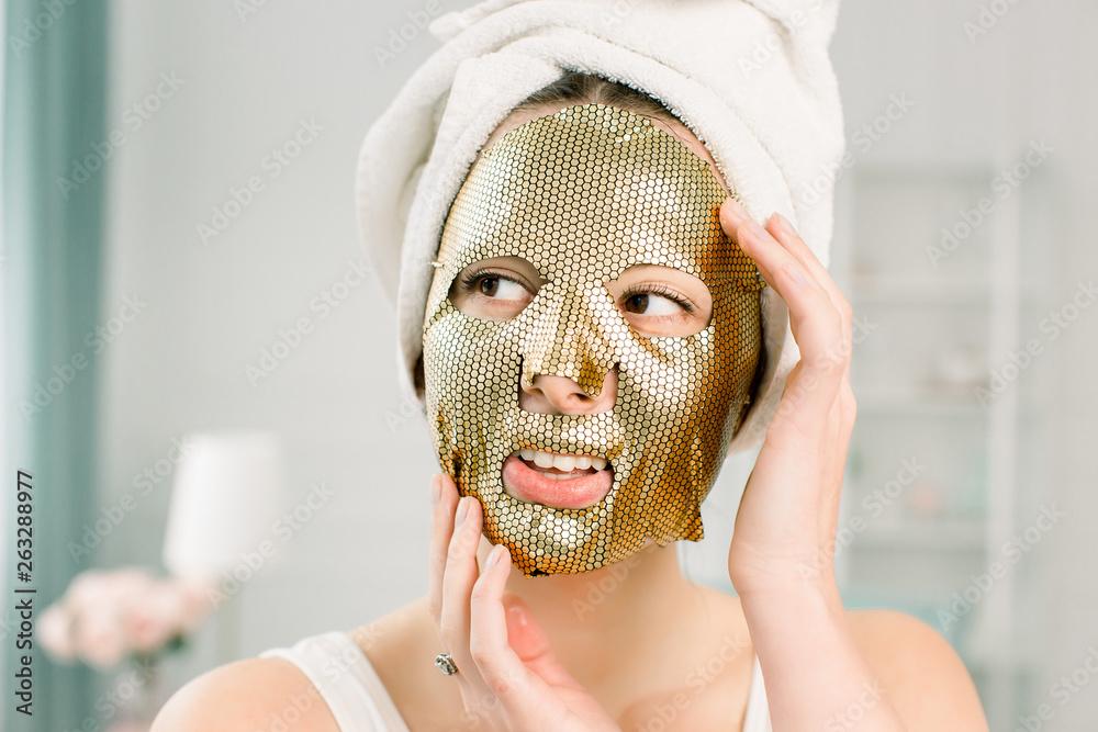 Cosmetic procedure, Portrait Of Beautiful Female Model With Golden Face Product On Fresh Skin. Skin Care concept Cosmetic procedure, Portrait Of Beautiful Female Model With Golden Face Product On Fresh Skin. Skin Care concept
