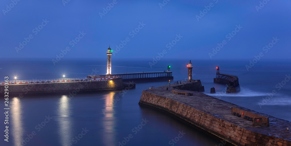 Whitby Harbor. Lighthouses on the East and West Piers. North Yorkshire. North Sea. England. Long exposure. Main focus on piers Whitby Harbor. Lighthouses on the East and West Piers. North Yorkshire. North Sea. England. Long exposure. Main focus on piers