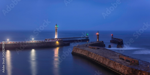  Whitby Harbor. Lighthouses on the East and West Piers. North Yorkshire. North Sea. England. Long exposure. Main focus on piers