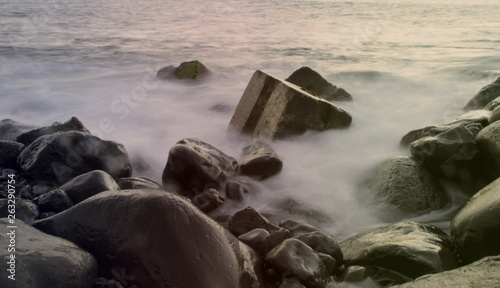 evening fog on the rocky ocean shore