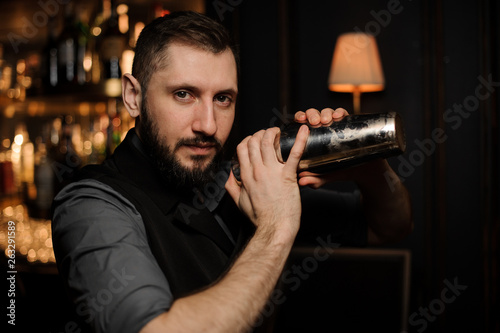 Male bartender with shaker in his hands