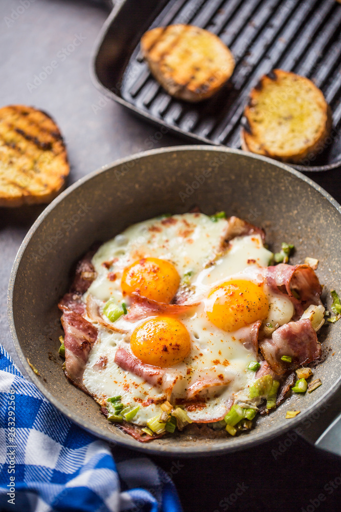 English breakfast fried bacon ham and eggs in ceramic pan English breakfast fried bacon ham and eggs in ceramic pan