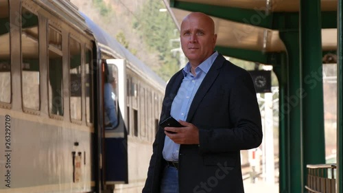 Wallpaper Mural Businessman Looking Around and Waiting Passengers from Train Wagons Torontodigital.ca