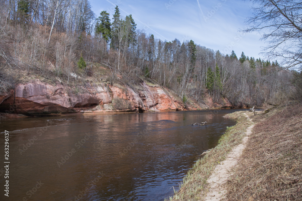  Red rocks and river Gauja. Nature and sun in spring. 2019.