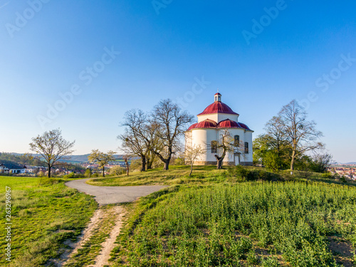 Aerial view of baroque chapel near Rosice city, Czech republic. Catholic religion building is national heritage of Czech republic. Sunny weather, agriculture land in background