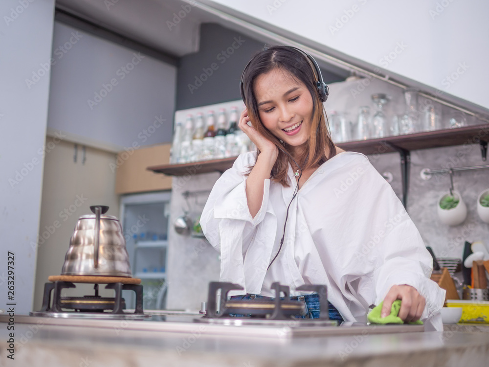 young happy asia housewife enjoy with her cleaning work at home or her coffee cafe young happy asia housewife enjoy with her cleaning work at home or her coffee cafe