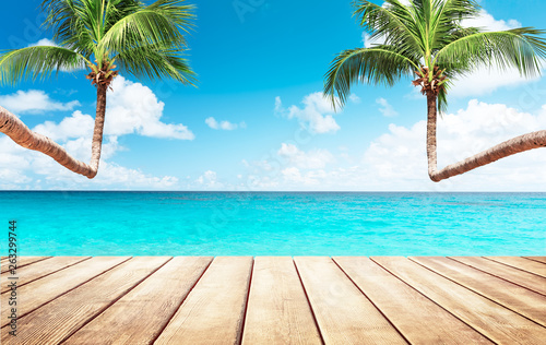 Blurred blue sky and sea with bokeh light and white wooden table background