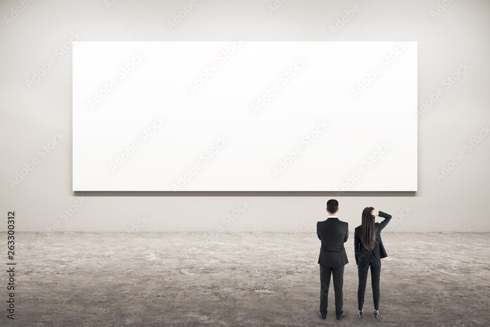 Businesspeople looking at poster Businesspeople looking at poster