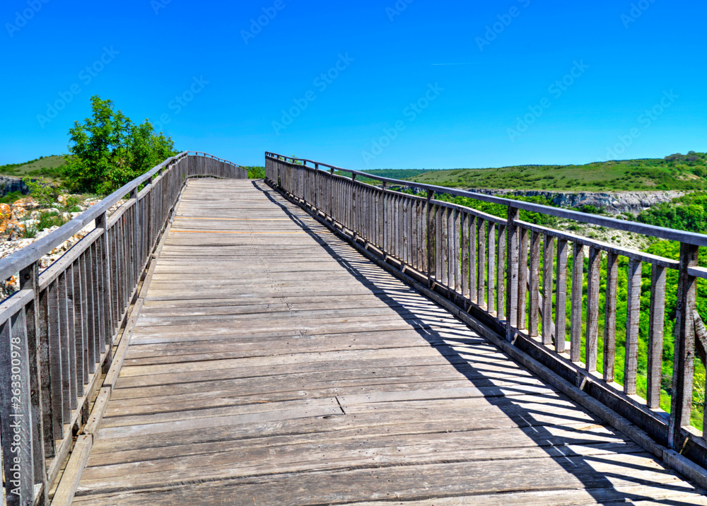 Beautiful landscape with wooden bridge in the mountain range