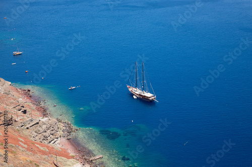 Santorini, Greece - July 07, 2017: Island Santorini. Luxury sailing yacht in the blue sea near the island