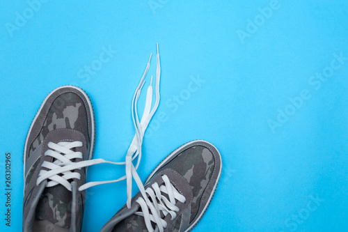 Pair of sneakers on color background, flat lay © Julia Kiseleva