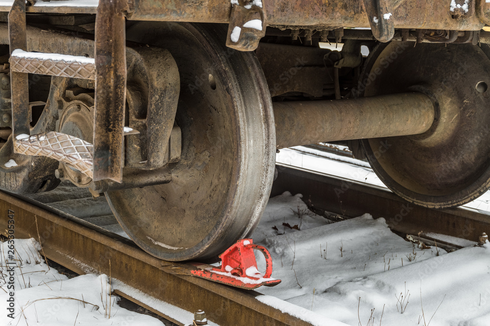 Railway brake shoe under the train wheel on the rails
