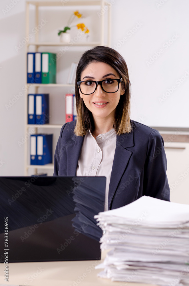 Young female employee working in the office Young female employee working in the office