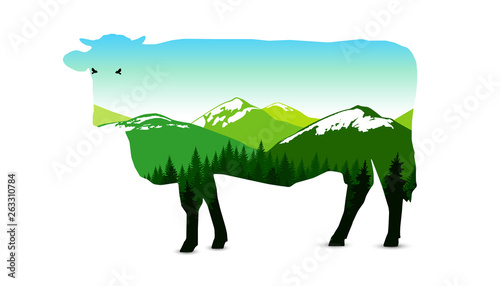 Silhouette of cow with panorama of mountains. Snowy peaks. Natural shades.