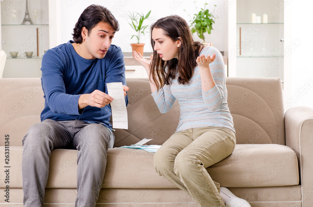 Obraz premium Young couple in budget planning concept 