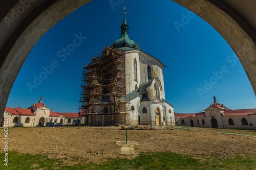 Zdar nad Sazavou, Czech Republic - April 19 2019: Pilgrimage Church of St John of Nepomuk at Zelena Hora, bright sunny day, clear blue sky, view through an arch, scaffolding due to reconstruction