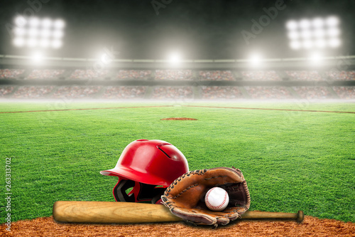 Baseball Bat, Helmet, Glove and Ball on Field in Outdoor Stadium With Copy Space