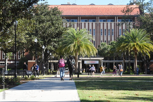 College students walk across the campus of UF between classes