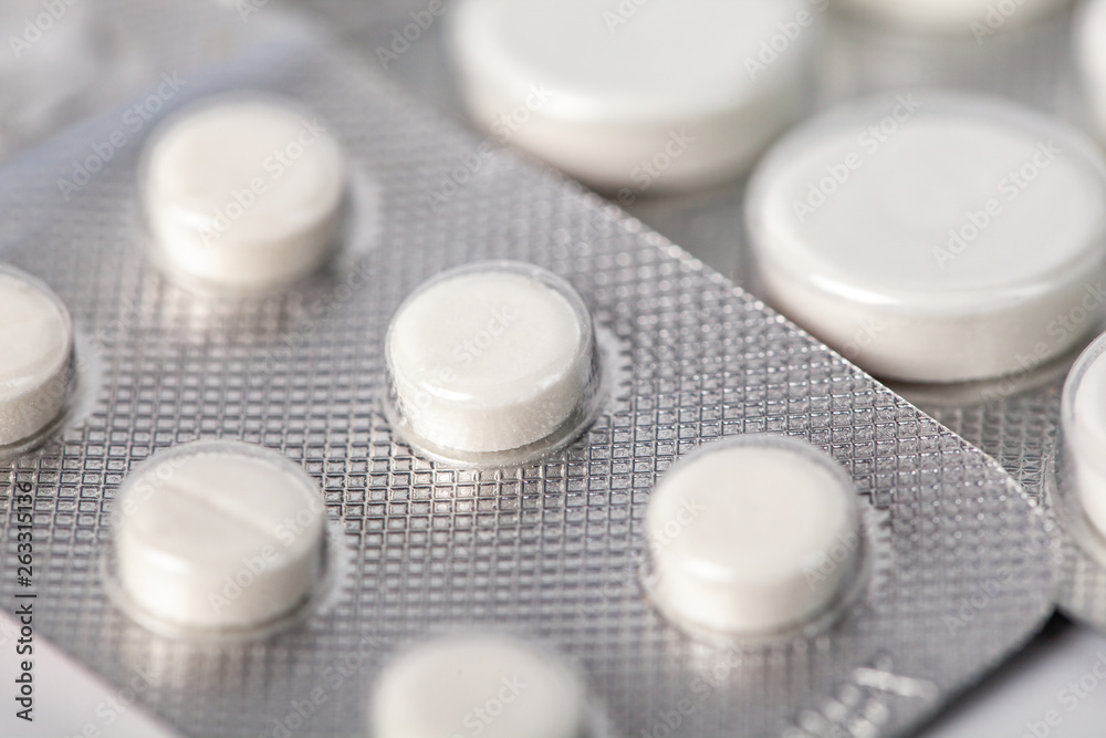 packing of white tablets, Packs of white pills packed in blisters packing of white tablets, Packs of white pills packed in blisters
