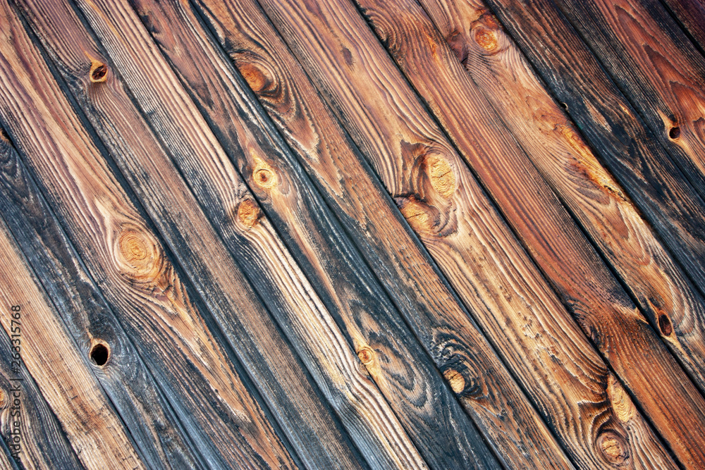 Naklejka premium The wall of old logs and boards natural wood. Diagonal boards create a pattern with natural pine texture.