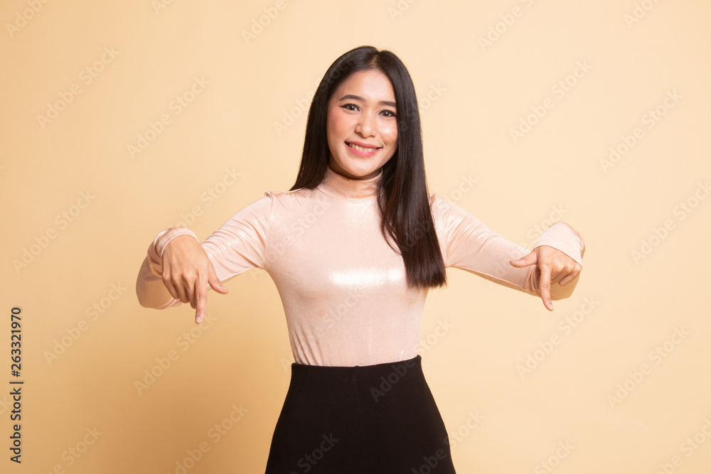 Beautiful young Asian woman point down to blank space. Beautiful young Asian woman point down to blank space.