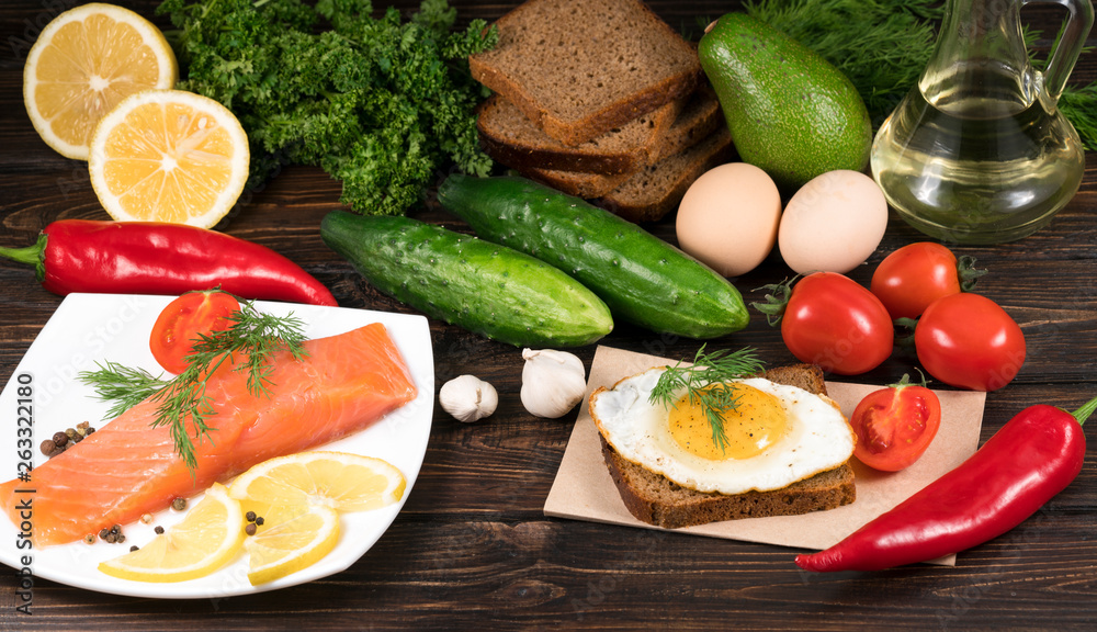 .red fish with lemon and vegetables on wooden background .red fish with lemon and vegetables on wooden background