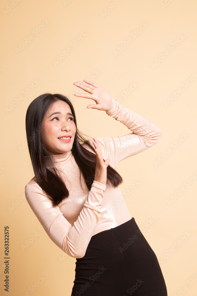 Excited young Asian woman look up. Excited young Asian woman look up.