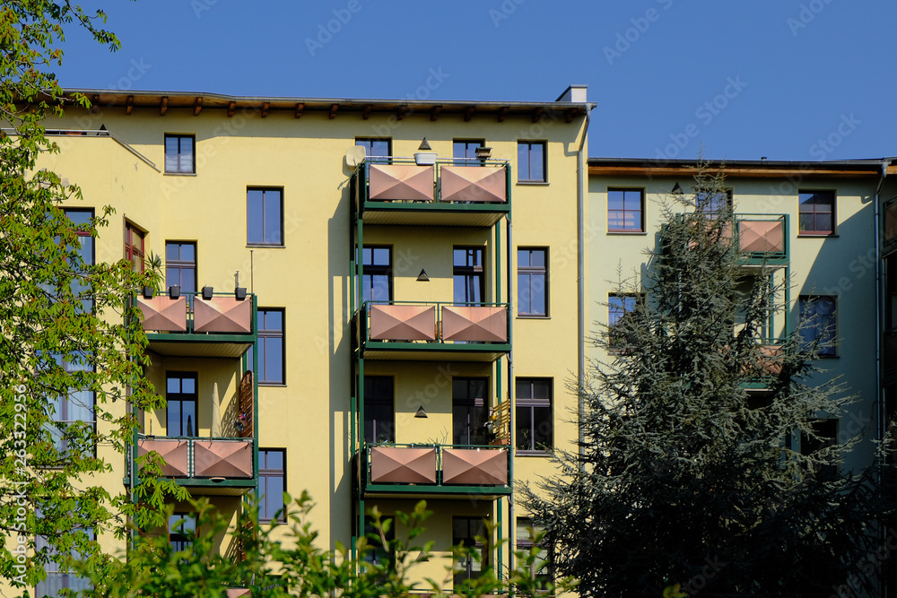 Fototapeta premium colorful apartment building with balconies in the countryside
