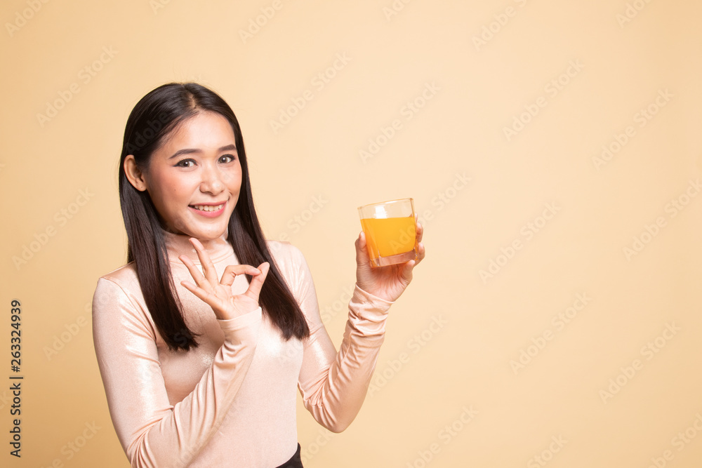 Young Asian woman show OK drink orange juice. Young Asian woman show OK drink orange juice.