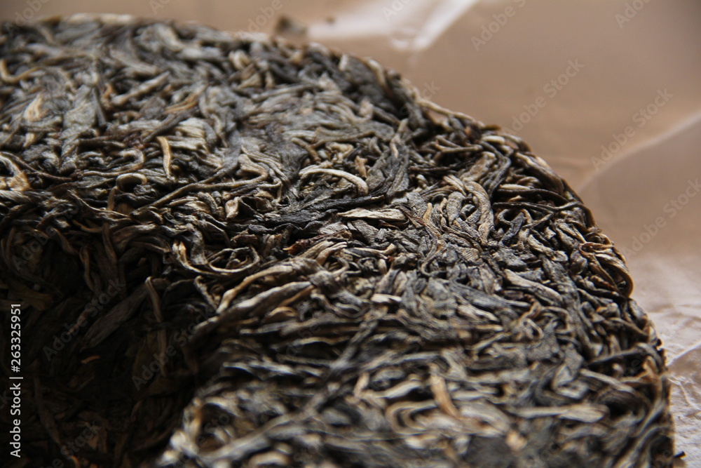 pressed tea in round cake on parchment paper pressed tea in round cake on parchment paper