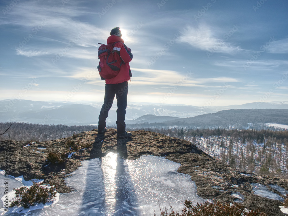 Obraz premium Standing man with raised arm on icy stone